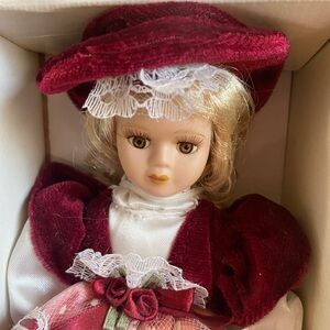 Genuine Hand painted 6” porcelain doll.  Brown eyes, blonde hair.